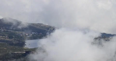 View over Serra da Estrela landscape with a lake and houses around Stock Footage 230672892