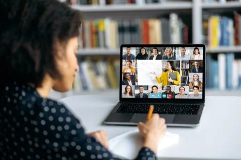 View over shoulder of an mixed race clever female student at a laptop screen Photos