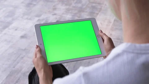 View over shoulder on tablet device in hands of Caucasian woman Stock Footage 135802854