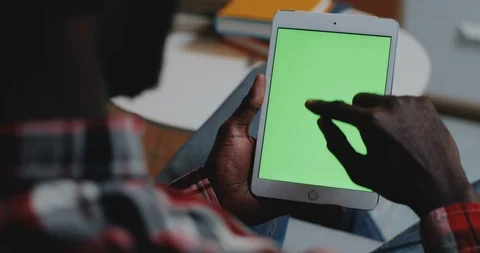 View over the shoulder on the white tablet device with green screen in hands of 스톡 동영상 104227953
