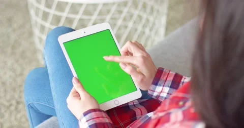 View over shoulder on white vertical tablet device in hands of Caucasian woman Stock Footage 131351084
