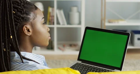 View over the shoulder on the young African American woman with pigtails sitting Video stock 90249759