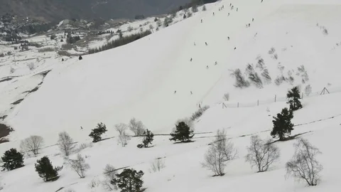 View over the ski slopes and facilities of chairlift up the mountain s Stock Footage 71065056