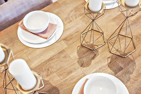 View over the table with candles and white plates Stock Photos