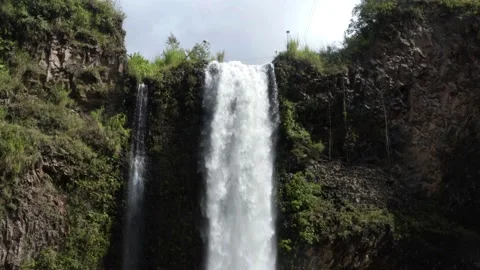 View over the top of a waterfall where the water is starting to fall down Stock Footage 155302857