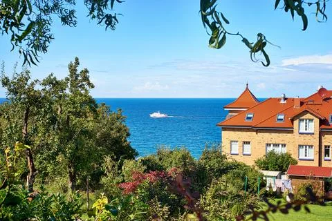 View over the trees on a passenger ship on the Baltic Sea. Living in Lohme on Stock Photos
