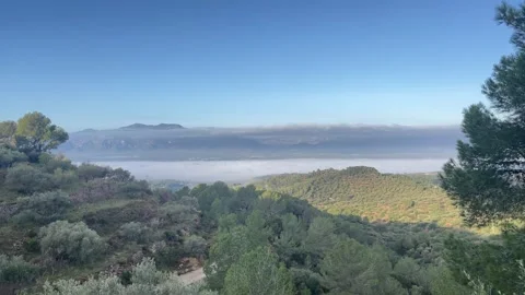 View overlooking Els Ports mountains and Tortosa town covered in fog Stock Footage 327629510