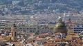 View overlooking maroon rooftops and towers of big city on sunny day, panorama 4k or 4k+ Resolution
