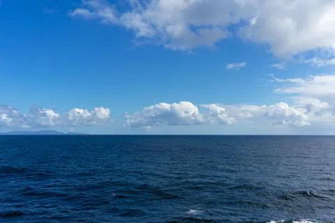 View of the Pacific Ocean and  blue sky with clouds and horizon Stock Photos