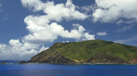View of Pacific Ocean and mountain covered with greenery in Pitcairn Islands Stock Footage 51479861