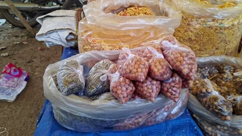 View of packaged snack items displayed in street market stalls showcasing v.. Stock Footage 337038335