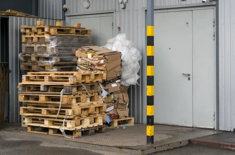 View on pallets, boxes in front of the door of the warehouse or store Stock Photos