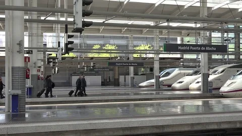 View of pan right modern Madrid central train station indoor passenger people Stock Footage 81977679