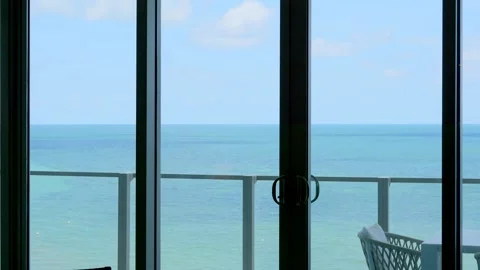 View from panoramic window on summer terrace with table and comfortable chairs Видео 247085969