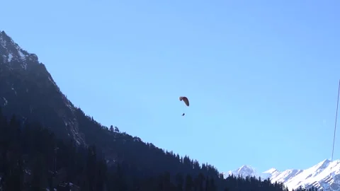 View of the parachute above the snow covered mountain peak at Solang Valley Stock Footage 155203859