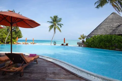A view of paradise relaxing by an infinity pool view in the Maldives Stock Photos