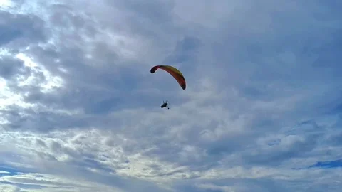 View of paramotor passed with beautiful sky cloud and waves on the beach Stock Footage 307191518