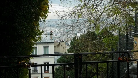 View of Paris rooftops through the tree branches of one of the small Stock Footage 125067637