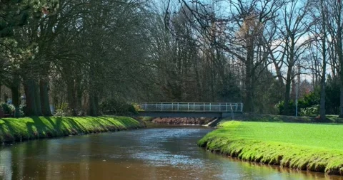 A view of the park and a deserted bridge on a sunny spring day. 4K Stock Footage 245417779