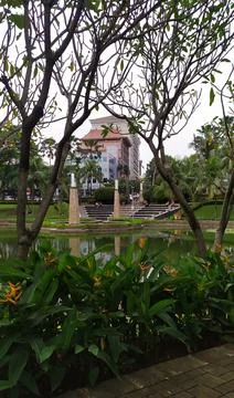 A view of a park, trees with a pond between skyscrapers Stock Photos