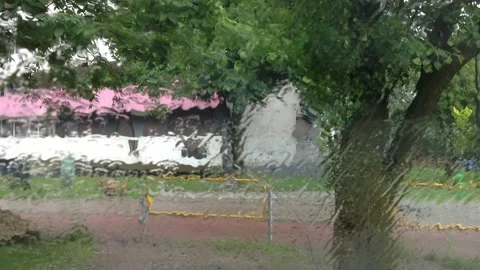 View from a parked car through a window wet with rain Stock Footage 119856425