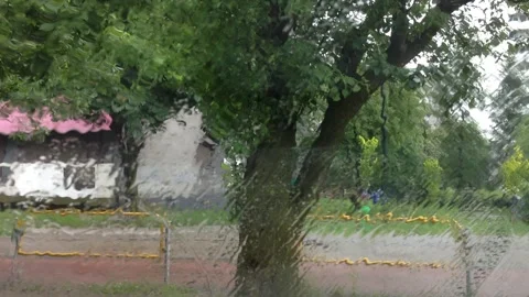 View from a parked car through a window wet with rain Video stock 119856654