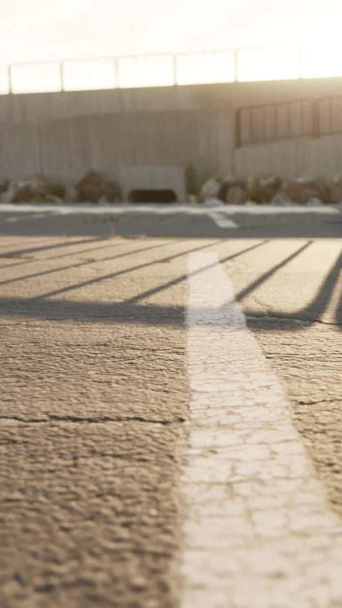 View of a parking lot with shadows during sunset in a quiet area Stock-Footage 338382623