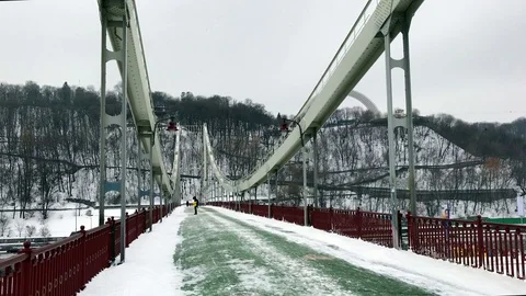 View of Parkovyi bridge in winter over frozen Dnipro Video stock 71342907