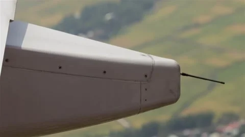 View on part of flying airplane over land - static wicks - static discharges Stock-Footage 343938380
