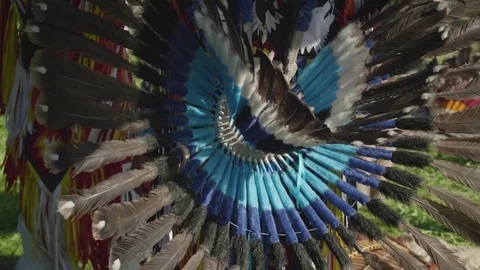 View of part of Peruvian dress made of feathers on true Peruvian playing flute Stock Footage 78242628