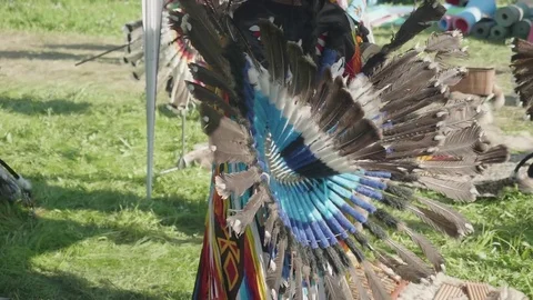 View of part of Peruvian dress made of feathers on true Peruvian playing flute Stock Footage 78243080