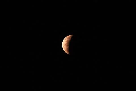 View of the partial lunar eclipse in the dark sky Stock Photos