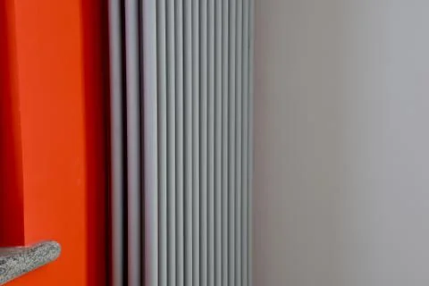 View of particular red colored wall with gray colored towel warm 스톡 사진