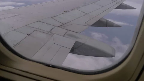 View from the Passenger Airplane Window on the Wing Flying above the Clouds Stock Footage 97792495
