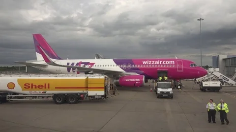 View of passenger get off airplane worker unloading baggage people traveler fly Stock Footage 82372517
