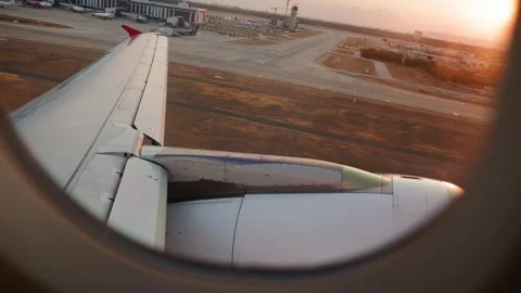 View from Passenger Plane Window During Takeoff with Mountains at Sunset. Stock Footage 345275760
