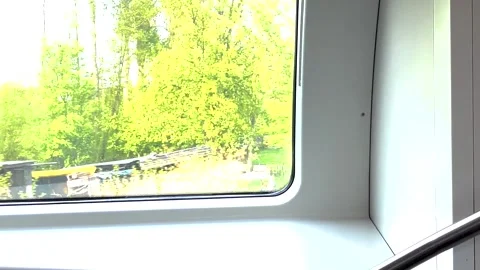 A view from the passenger window of a moving train travelling at speed through Stock Footage 273178117