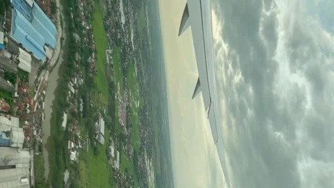 View from the passenger window, the plane passing through residential areas  Stock Footage 251166650
