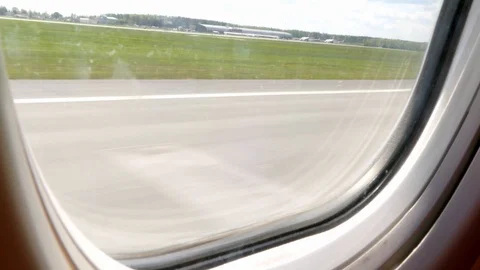 View from passenger window, plane starting, taking off from airport runway Stock Footage 89877243