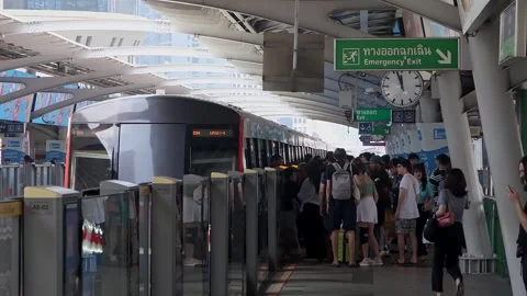 View of passengers boarding BTS skytrain at Asok metro station. Stock Footage 283947813
