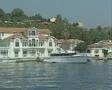 View passing riverside house with yacht SD Footage