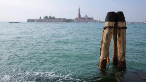 View past mooring posts towards San Giorgio Maggiore, Venice, Italy Stock Footage 258256349