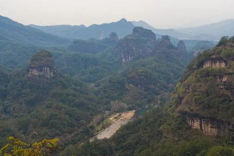 View on the path to DaWang Peak. Trees in foreground Stock Photos