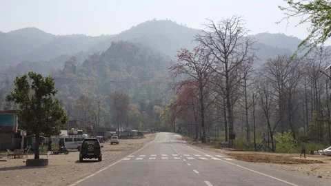 View of a paved road leading towards hazy mountains in Surkhet, Nepal. Video stock 335466003