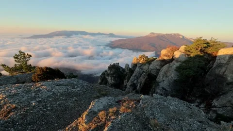 View from peak of high mountain with white floating clouds and rocks at dawn Video stock 169843253