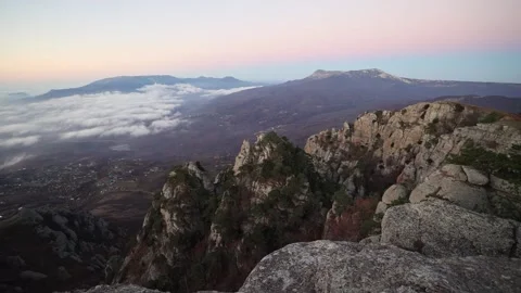 View from peak of high mountain with white floating clouds and rocks at dawn Stock Footage 170007472