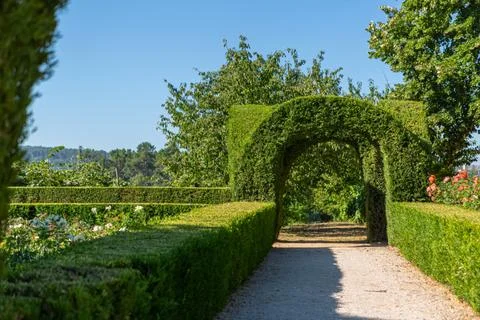 View of a pedestrian path on iconic and geometric classic baroque garden Stock Photos