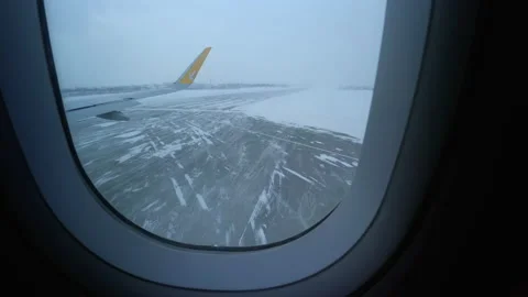 View from Pegasus airplane getting on the takeoff strip in the snowy airport in Stock Footage 152604511