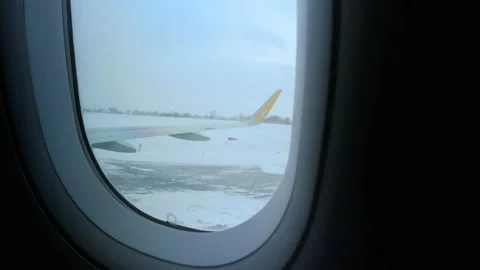 View on Pegasus airplane on the plane wing and the snowy takeoff-landing strip Stock Footage 152760650