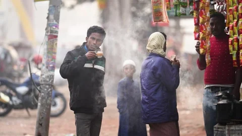 View of people drinking tea at a roadside stall in Bogura, Bangladesh. Video stock 334971074